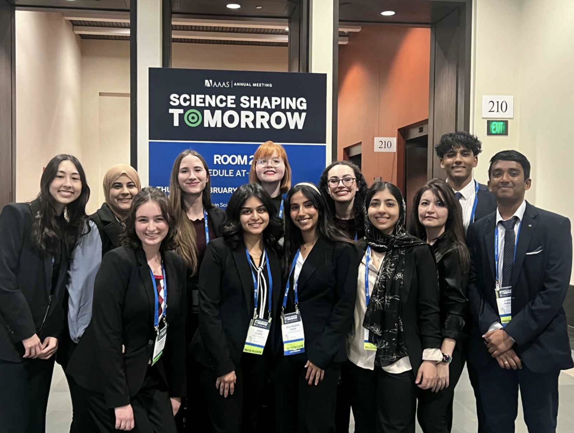 ASU students posing for a photo in front of a sign for the AAAS 2025 Annual Meeting.